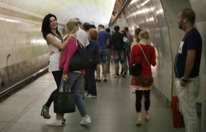 Women joke with each other on the platform in Turgenevskaya metro station in Moscow.