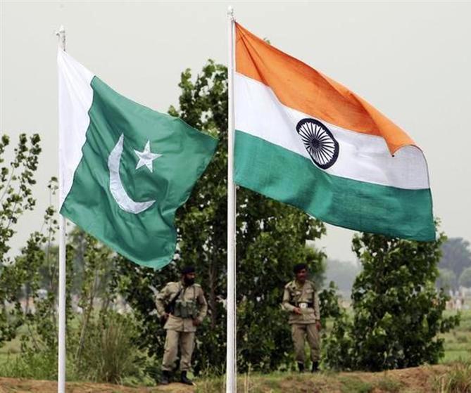 This file photograph shows Pakistani rangers standing near the Indian (R) and Pakistani national flags during an annual fair near Pakistan border in Chamliyal, 45 km (28 miles) west of Jammu.
