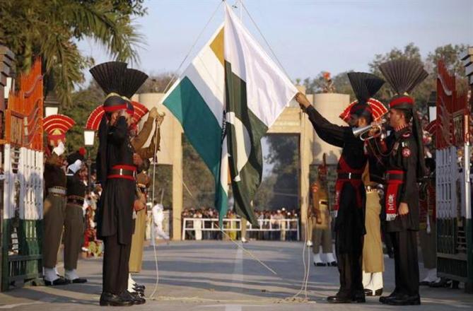 This file photograph shows Pakistan Rangers (R) and Border Security Force personnel taking part in the daily flag lowering ceremony at their joint border post of Wagah near Lahore. 