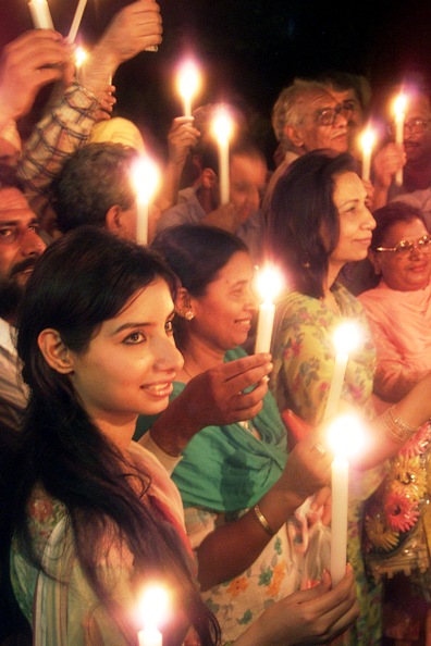 This file photograph shows members of India and Pakistan delegations lighting candles to celebrate Indian and Pakistani Independence Day in Wagha.