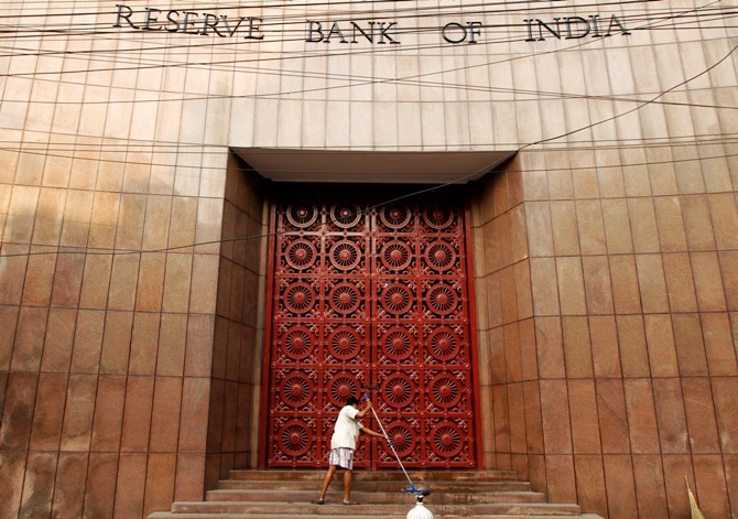 A worker cleans the stairs of the Reserve Bank of India building in Kolkata.