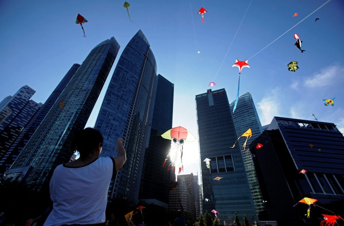 People fly kites during the annual Singapore Kite Festival at the central business district area of Marina Bay in Singapore.