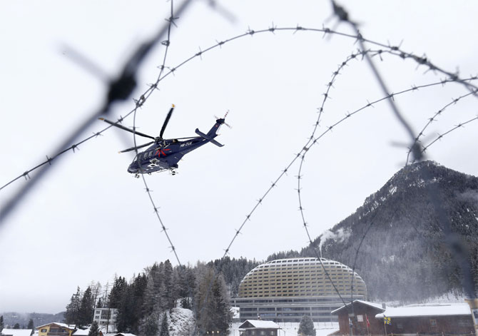 A helicopter starts in front of the InterContinental Hotel before the start of the annual meeting of the World Economic Forum.