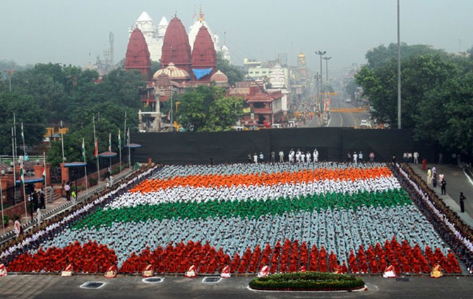 School children in coloured clothes form India's flag as they participate in a full-dress rehearsal for the country's Independence Day celebrations at the Red Fort in Delhi.