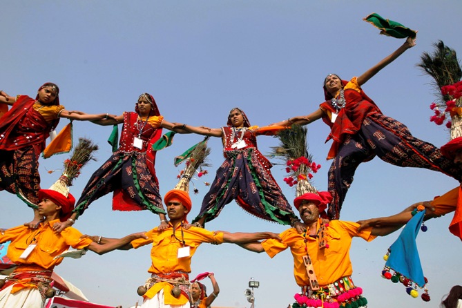 Folk dancers wearing traditional attire perform at the international kite festival in Ahmedabad.