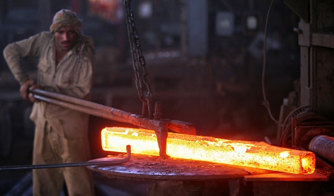 A labourer works inside an iron factory on the outskirts of Jammu.