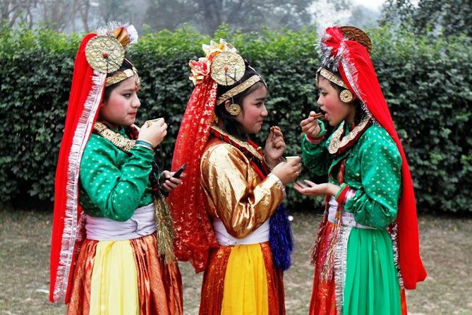 Indian folk dancers drink tea before performing during the full dress rehearsal for the Republic Day parade in Kolkata.