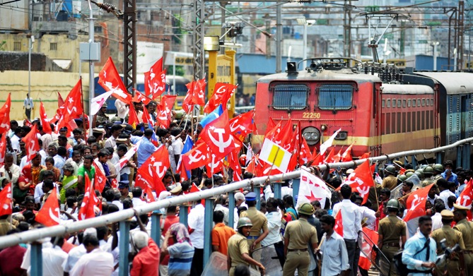 Activists of the Communist Party of India-Marxist (CPI-M) block a passenger train while protesting during a nationwide strike in Chennai.