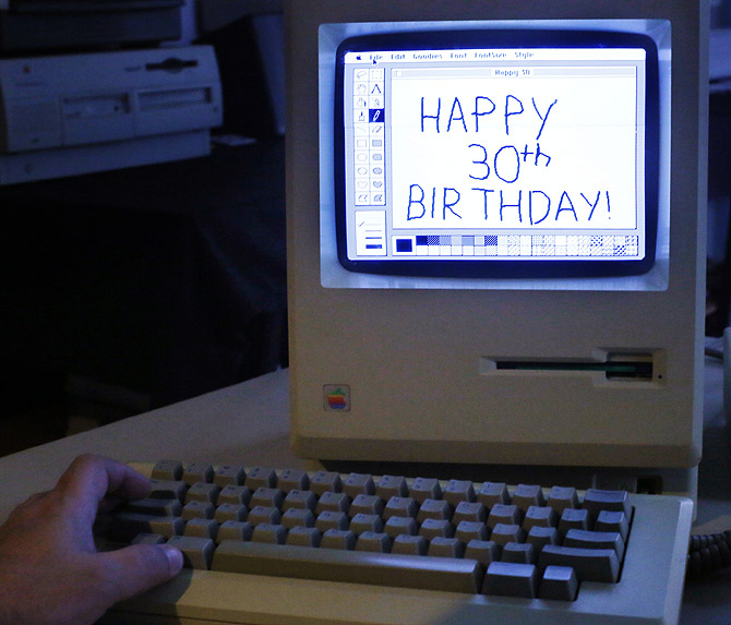 Curator Adam Rosen writes Happy 30th Birthday using version 1 of MacPaint on an original 128K Macintosh computer at the Vintage Mac Museum in Malden, Mass.