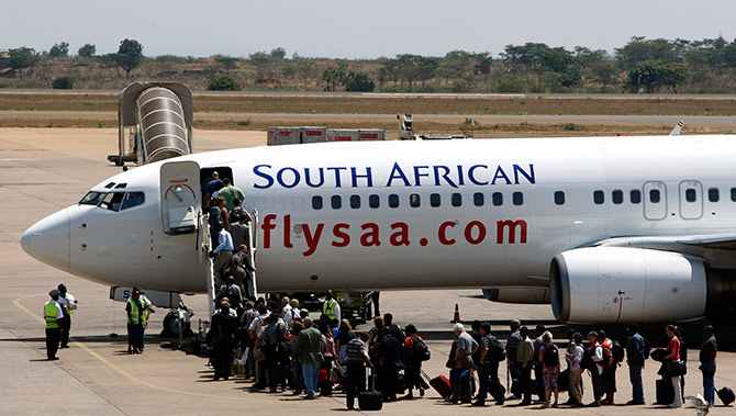Passengers board a South African Airways Boeing 737 aircraft at the Kamuzu International Airport in Lilongwe.