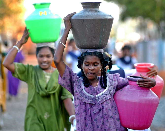 This file photograph shows women tsunami survivors carrying pots of drinking water in tsunami-hit Nagapattinam, Tamil Nadu.