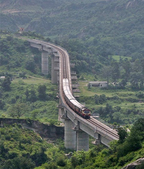  passenger train moves along the Jammu-Udhampur rail line on the outskirts of Jammu.