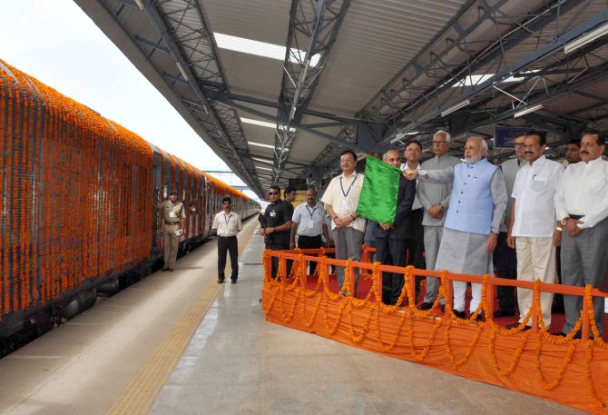 prime Minister Narendra Modi flags off a new train.