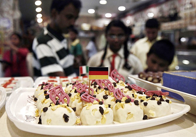 A German national flag is fixed on a piece of sweet at a sweet mart in Kolkata.