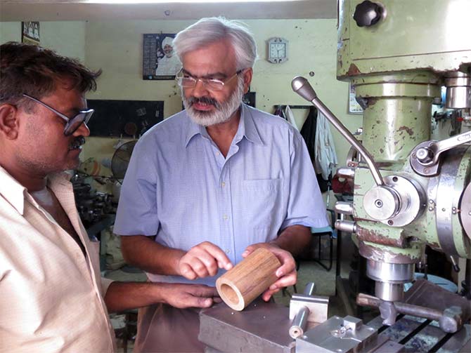 Yogeshwar Kumar instructing a technician on fabrication of equipment for power house. He has been designing power station and gets equipment fabricated in small units in Delhi