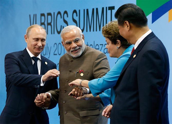 (L-R) Russia's President Vladimir Putin, India's Prime Minister Narendra Modi, Brazil's President Dilma Rousseff and China's President Xi Jinping pose for a group picture during the VI BRICS Summit in Fortaleza.