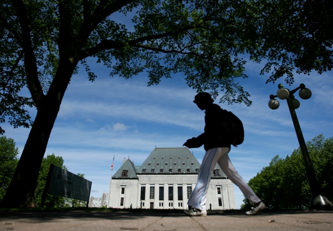 A woman walks past the Supreme Court of Canada in Ottawa.