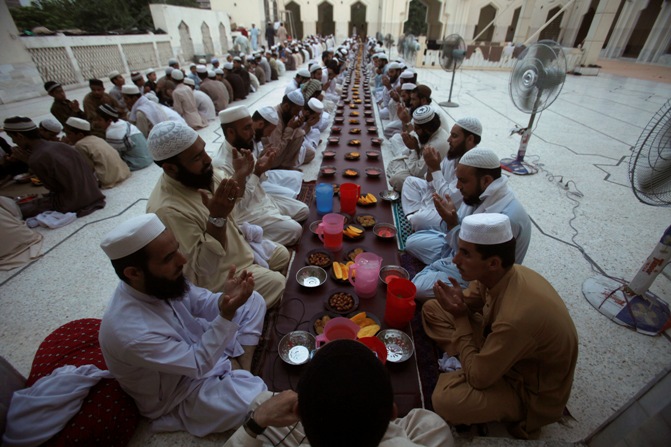 Men pray before breaking their fast on the first day of Ramadan, the holiest month in the Islamic calendar, at a mosque in Peshawar.