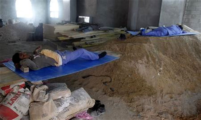 Construction workers rest during their lunch break.