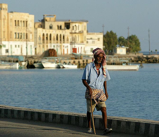 An Eritrean man walks alongside the Red Sea port of Massawa.