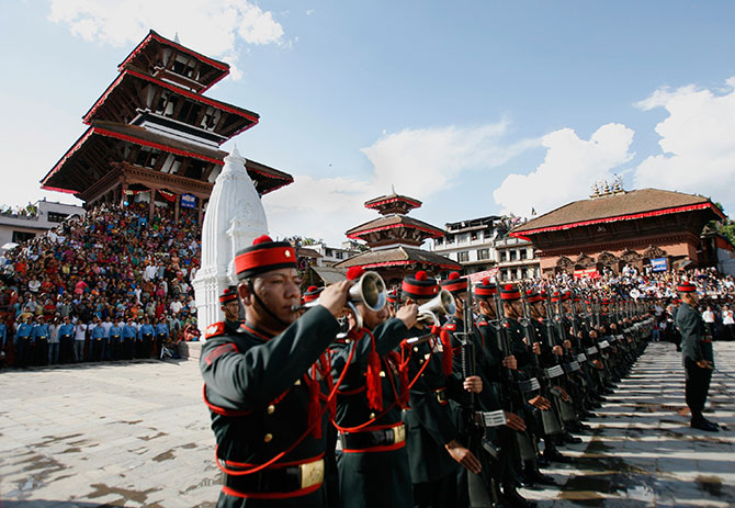 People watch as the guard of honour for Nepal's President Ram Baran Yadav (not pictured) stands at attention during the Indrajatra festival in Kathmandu.
