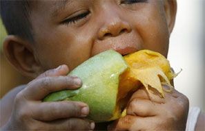 A child eats a mango