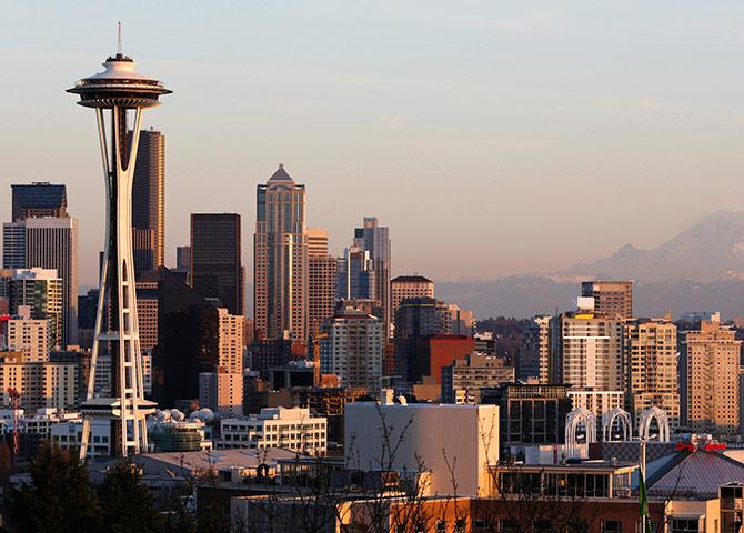 The Space Needle and Mount Rainier are pictured at dusk in Seattle, Washington.