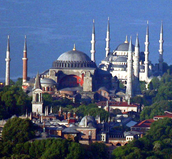 The sixth century Byzantinian monument of St. Sofia (Ayasofya) and the 16th century Ottoman era Blue Mosque are seen behind the Topkapi Palace.