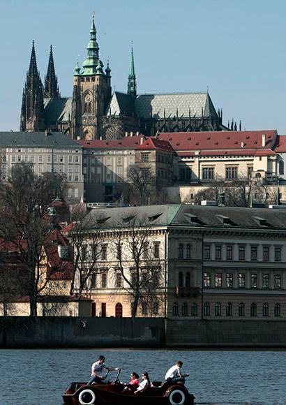 People enjoy the sunny spring weather as they ride a pedal-boat on the Vltava river in Prague.