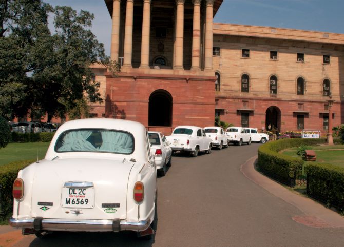 Official Hindustan Ambassador cars waiting in line outside North Block.