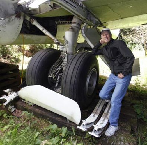 Bruce Campbell leans on a tyre of his Boeing 727 home.