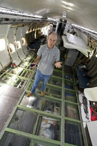 Bruce Campbell stands on the plexiglass floor of his Boeing 727 home.