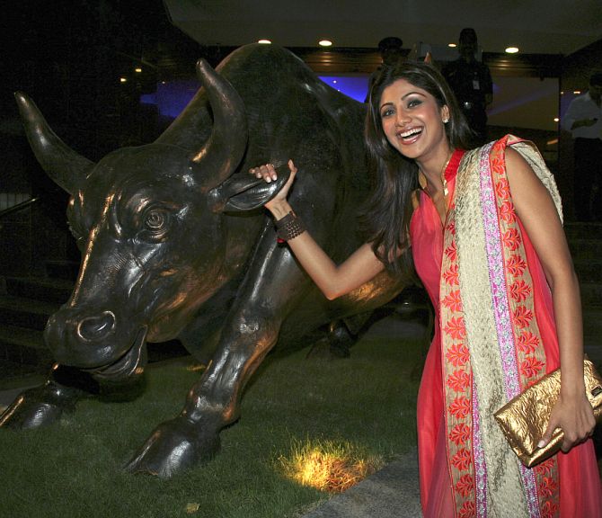 Actress Shilpa Shetty poses outside the Bombay Stock Exchange building.