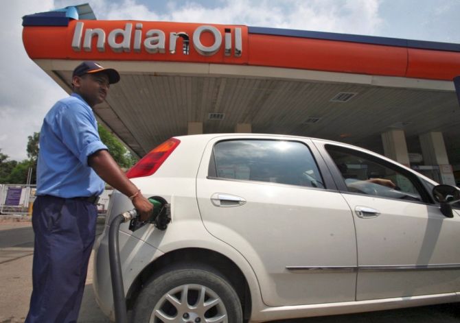 A worker fills a car with diesel at a fuel station in Jammu.