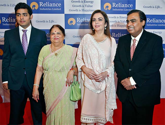 Mukesh Ambani (R), chairman of Reliance Industries Ltd, poses with his wife Nita (2nd R), mother Kokilaben (2nd L) and son Akash, before addressing the company's annual shareholders' meeting in Mumbai.