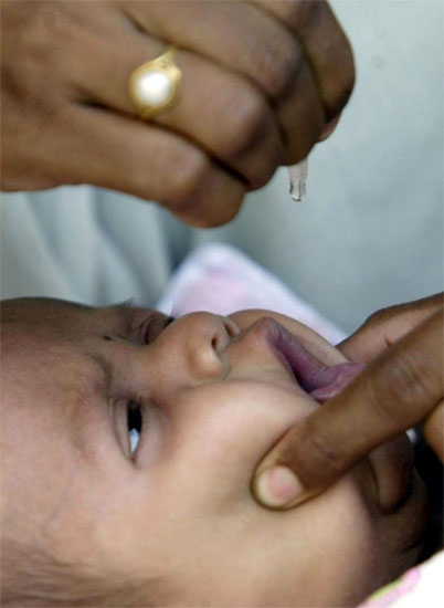 A child receives polio drops at a polio booth in Bhopal.