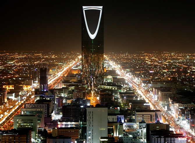 The Kingdom Tower stands in the night in Riyadh.
