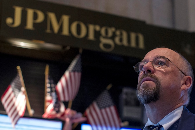 JP Morgan Securities Frederick Reimer works in his company's stall on the floor of the New York Stock Exchange.