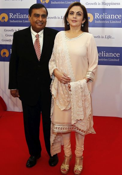 Mukesh Ambani (L), chairman of Reliance Industries Ltd, poses with his wife Nita before addressing the company's annual shareholders' meeting.