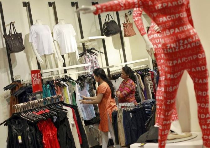 People shop for clothes during a seasonal sale at a store inside a shopping mall in Mumbai.
