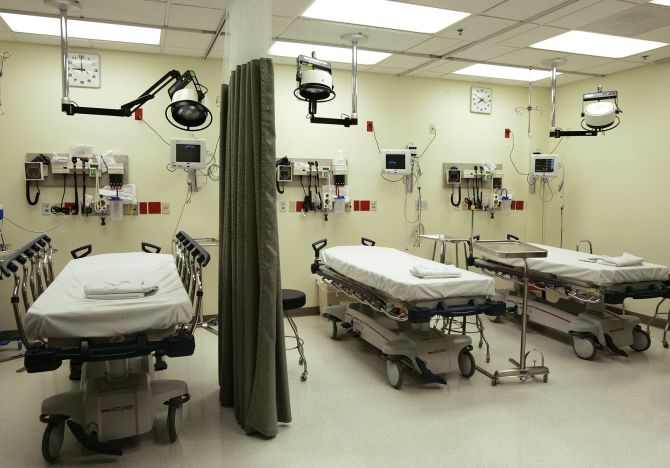 Beds lie empty in the emergency room of a hospital.