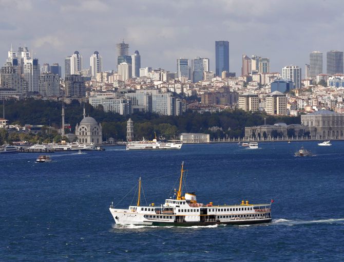 A ferryboat moves along the Bosphorus and past the city's skyscrapers (rear) in Istanbul.