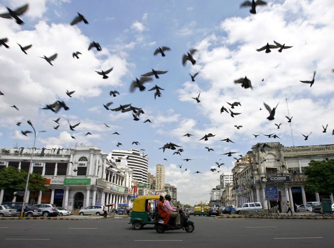 Pigeons fly as clouds gather over New Delhi's Connaught Place.