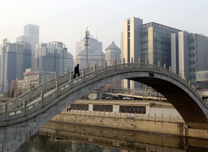 A man walks on a bridge in Beijing.