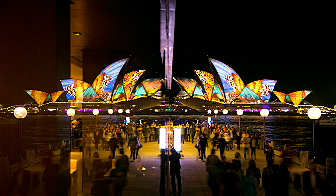An image of butterflies is projected onto the sails of the Sydney Opera House, reflected in a hotel window on the opening night of the Vivid Sydney light and music festival.