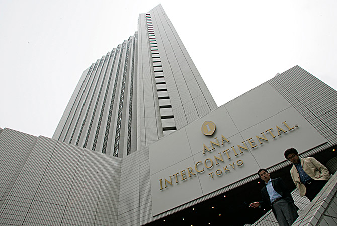 Pedestrians walk past ANA Intercontinental hotel, one of the hotel chains of All Nippon Airways, in Tokyo.