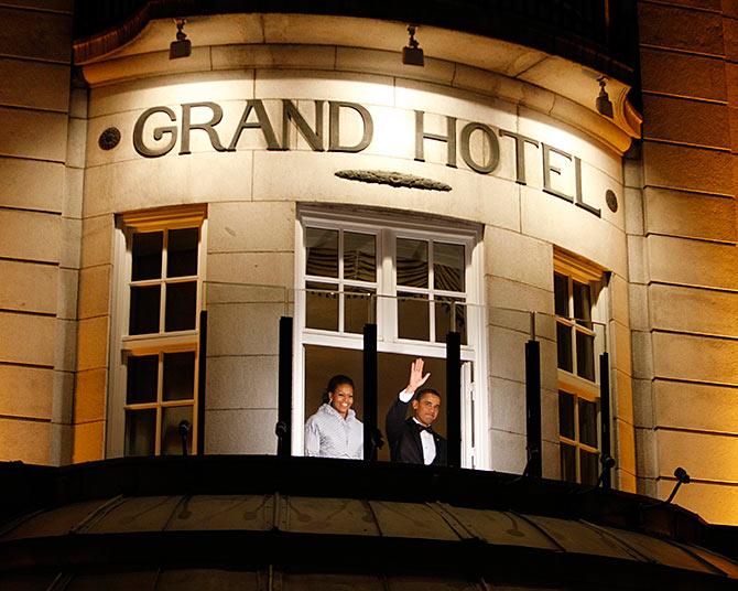 U.S. President Barack Obama acknowledges the crowd as he and his wife Michelle stand on the balcony of the Grand Hotel in Oslo.