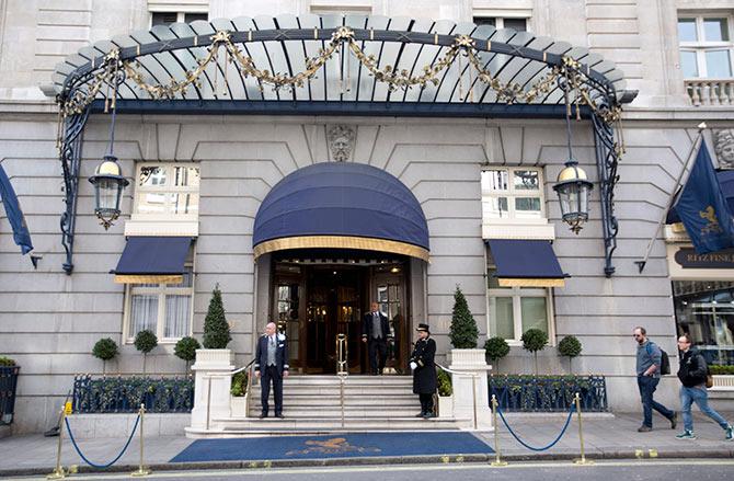 Pedestrian's walk past the Ritz Hotel in central London.