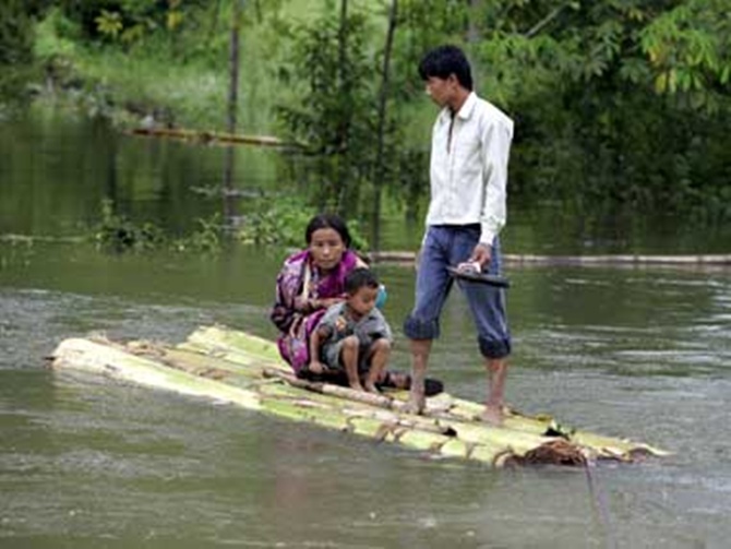 Villagers move from a flood-hit village in Arunachal Pradesh.