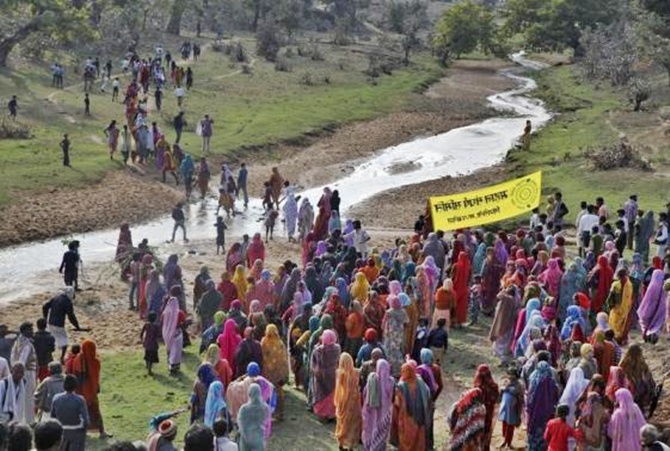 Villagers walk towards the Mahan forest during a protest against a coal mining project in Singrauli district in Madhya Pradesh. 